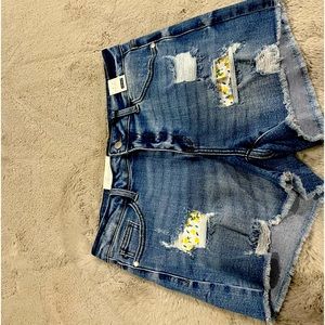 Women’s blue jean shorts with lemon rip covers
